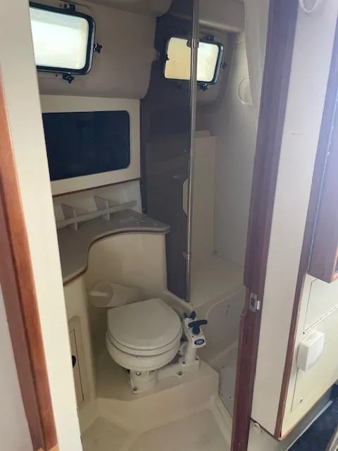 Slide: The Image of Interior of 2001 Albin 31' Tournament Express boat showing compact bathroom with toilet and shower. - 12