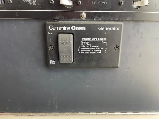 Slide: The Image of Cummins Onan generator control panel on 2001 Albin 31' Tournament Express boat. - 15