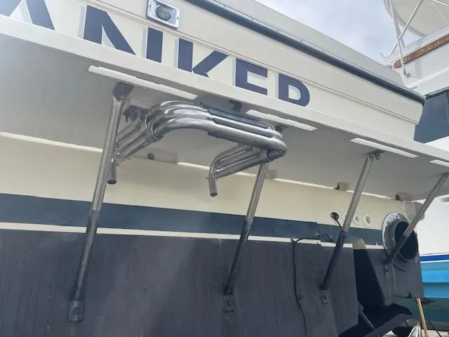 Slide: The Image of 2001 Albin 31' Tournament Express boat stern with metal ladder and partial name visible. - 22
