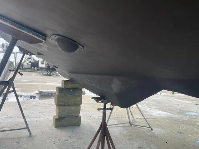 Slide: The Image of 2001 Albin 31' Tournament Express boat hull on stands in a shipyard. - 25