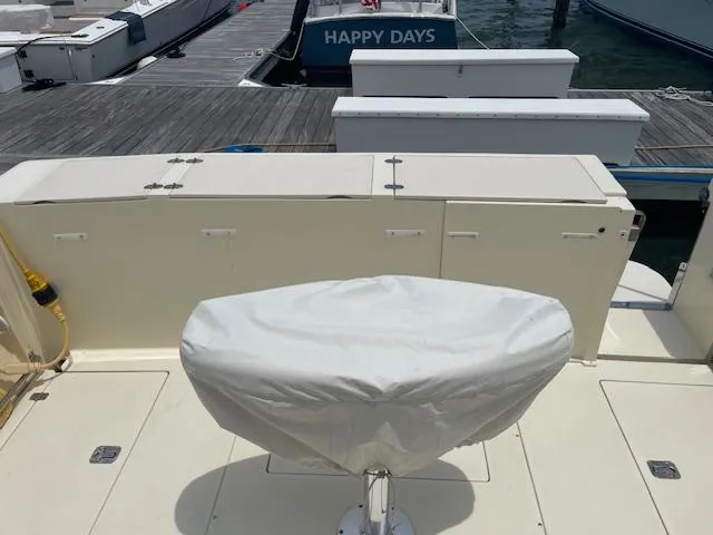 Slide: The Image of 2001 Albin 31' Tournament Express boat docked, covered seat, and "Happy Days" boat in background. - 8
