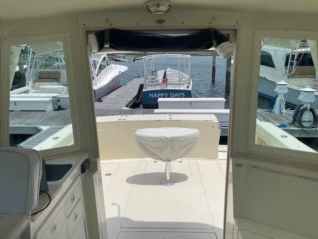 Slide: The Image of 2001 Albin 31' Tournament Express boat interior at marina, featuring docked boats. - 9