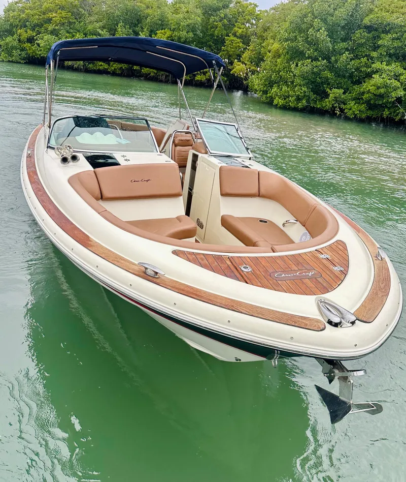 Slide: The Image of 2015 Chris-Craft Launch 32 boat with tan seating, docked on calm water. - 5