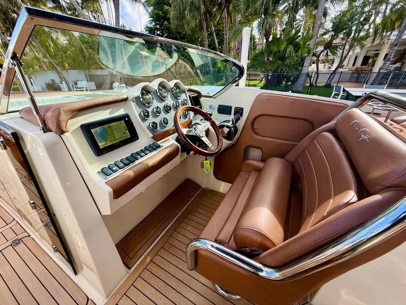 Slide: The Image of 2015 Chris-Craft Launch 32 cockpit with brown leather seats and modern dashboard controls. - 6