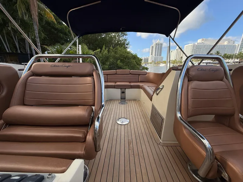 Slide: The Image of 2015 Chris-Craft Launch 32 interior with brown leather seats and wooden deck. - 9