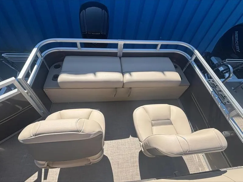 Slide: The Image of 2025 Sun Tracker SportFish™ 22 DLX boat interior with beige seating and railing. - 11