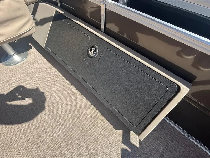 Slide: The Image of 2025 Sun Tracker SportFish™ 22 DLX boat storage compartment with secure latch. - 7