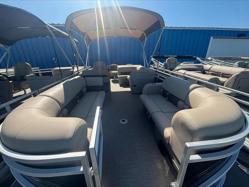 Slide: The Image of 2025 Sun Tracker SportFish™ 22 DLX pontoon boat with spacious seating and canopy under sunlight. - 8