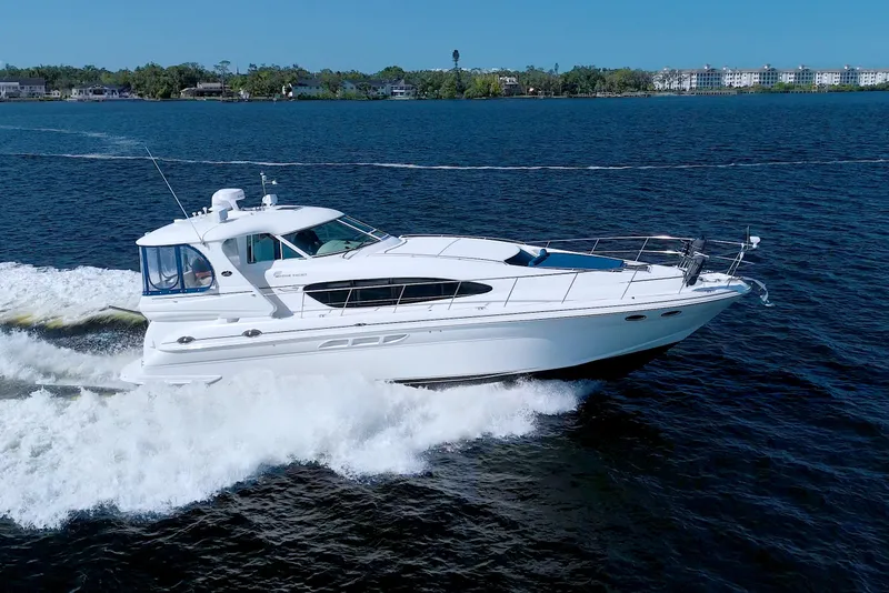 The Image of 2003 Sea Ray 480 Motor Yacht cruising on open water under clear blue sky. - 0