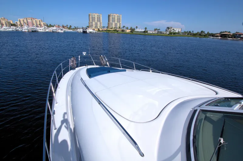 Slide: The Image of 2003 Sea Ray 480 Motor Yacht on calm water with cityscape background. - 10