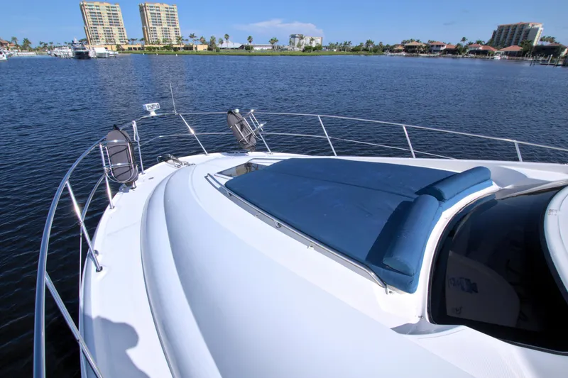 Slide: The Image of 2003 Sea Ray 480 Motor Yacht on calm water with cityscape background. - 11