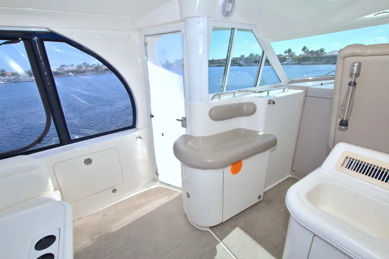 Slide: The Image of Interior of 2003 Sea Ray 480 Motor Yacht with seating and windows overlooking water. - 19