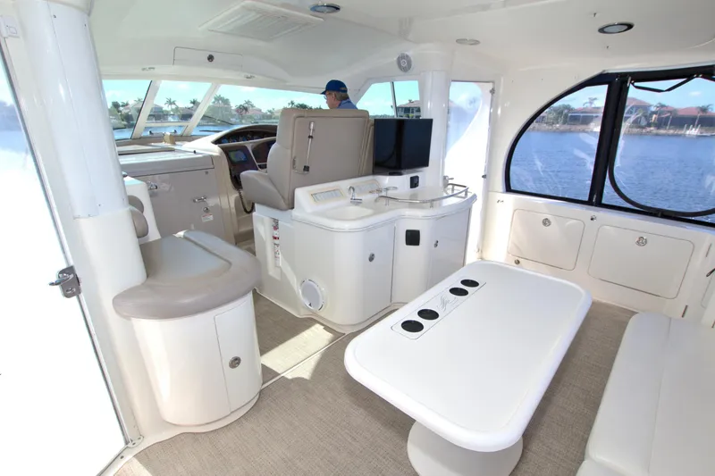 Slide: The Image of Interior of 2003 Sea Ray 480 Motor Yacht with seating and helm, overlooking water. - 20
