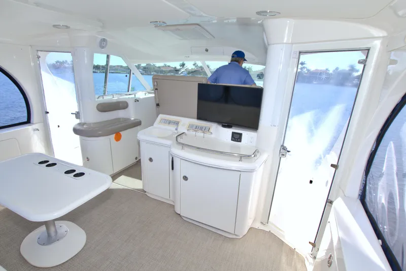 Slide: The Image of Interior of 2003 Sea Ray 480 Motor Yacht with modern seating and panoramic windows. - 22