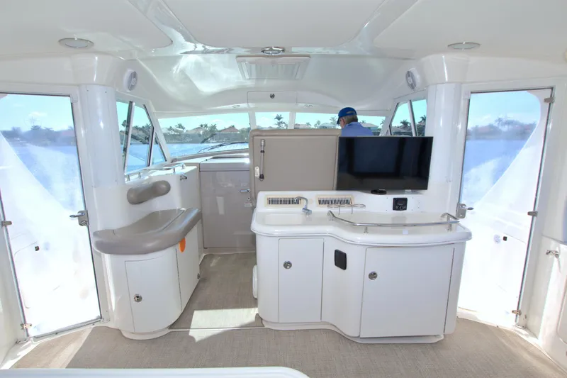 Slide: The Image of Interior of 2003 Sea Ray 480 Motor Yacht with modern amenities and panoramic windows. - 23
