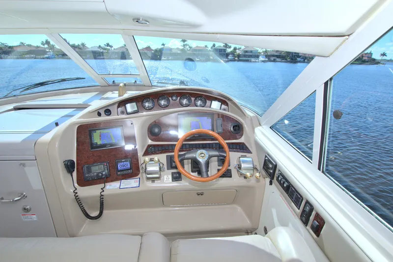 Slide: The Image of 2003 Sea Ray 480 Motor Yacht helm with navigation equipment and scenic water view. - 28