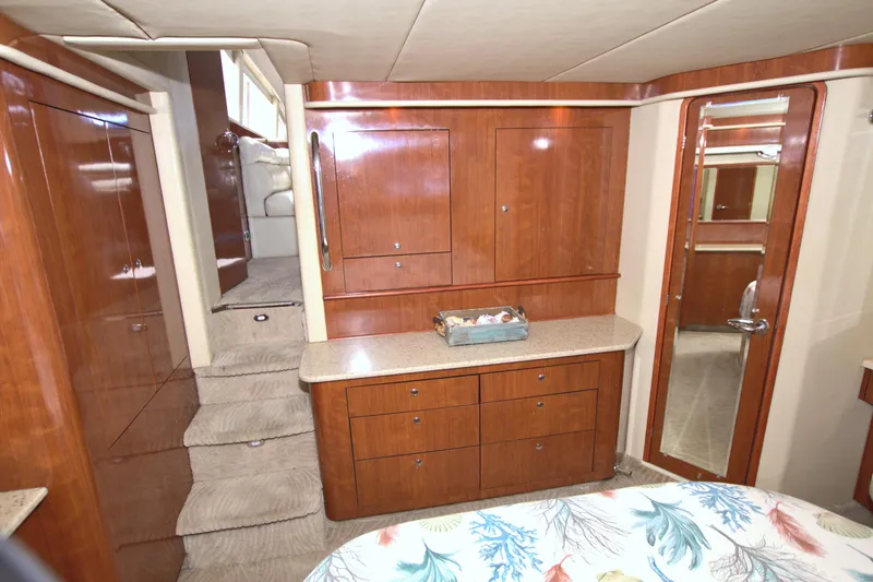 Slide: The Image of Interior of 2003 Sea Ray 480 Motor Yacht with wooden cabinetry and carpeted stairs. - 35