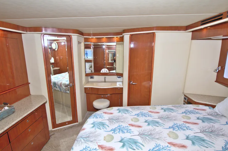 Slide: The Image of Luxurious 2003 Sea Ray 480 Motor Yacht cabin with elegant wood finishes and cozy bedding. - 36