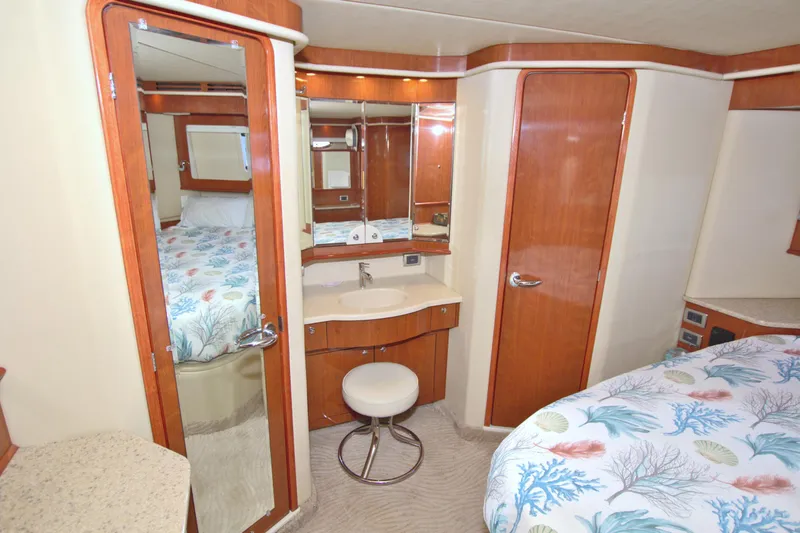 Slide: The Image of Luxurious 2003 Sea Ray 480 Motor Yacht interior with vanity, mirror, and cozy bedding. - 38