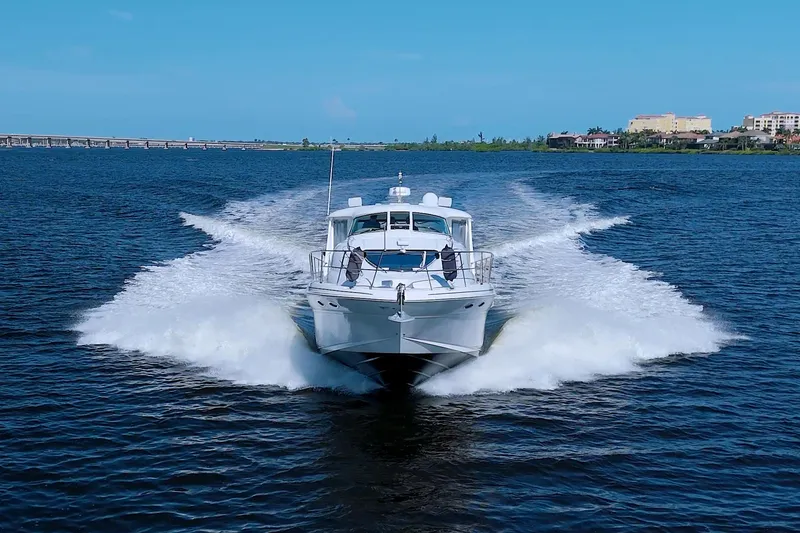 Slide: The Image of 2003 Sea Ray 480 Motor Yacht cruising on open water, creating a wake. - 4
