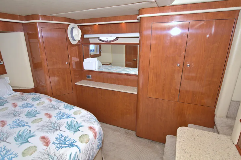 Slide: The Image of Luxurious 2003 Sea Ray 480 Motor Yacht cabin with wood cabinetry and patterned bedding. - 40