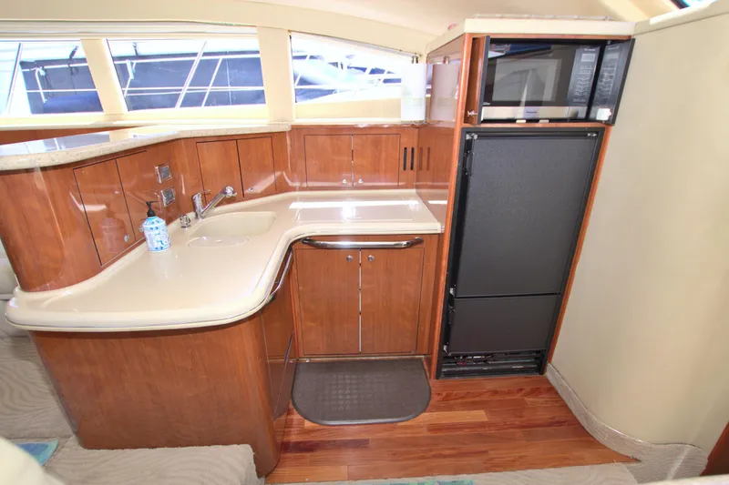 Slide: The Image of Luxurious 2003 Sea Ray 480 Motor Yacht kitchen with wood cabinetry and modern appliances. - 43
