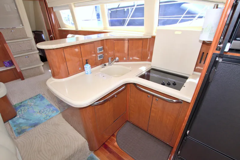 Slide: The Image of 2003 Sea Ray 480 Motor Yacht kitchen with wood cabinetry and modern appliances. - 44