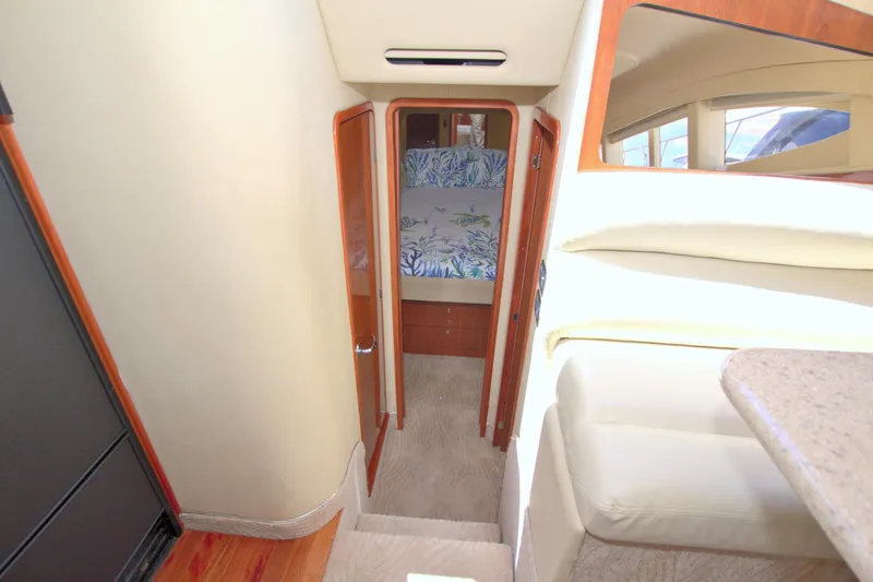 Slide: The Image of Interior view of 2003 Sea Ray 480 Motor Yacht cabin with bed and wooden accents. - 46