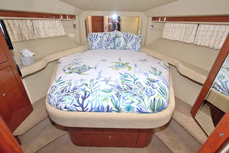 Slide: The Image of Luxurious bedroom interior of 2003 Sea Ray 480 Motor Yacht with marine-themed bedding. - 47
