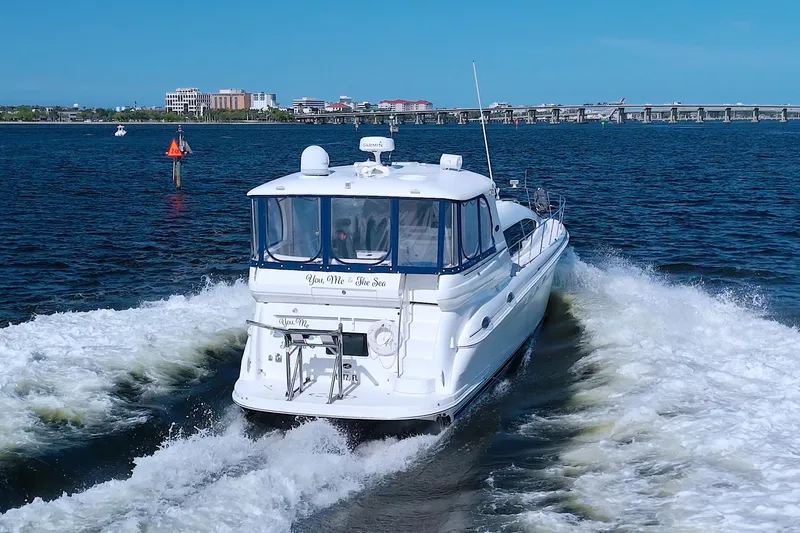 Slide: The Image of 2003 Sea Ray 480 Motor Yacht cruising on open water, creating a wake. - 7
