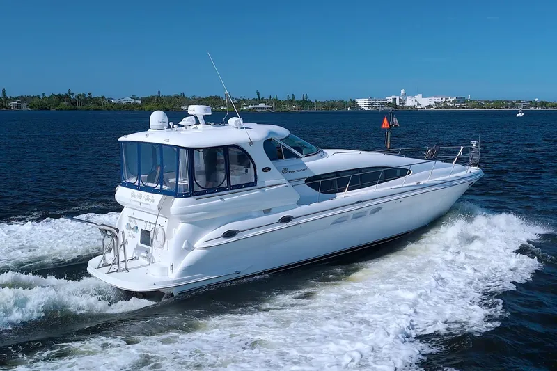 Slide: The Image of 2003 Sea Ray 480 Motor Yacht cruising on open water with cityscape in background. - 8