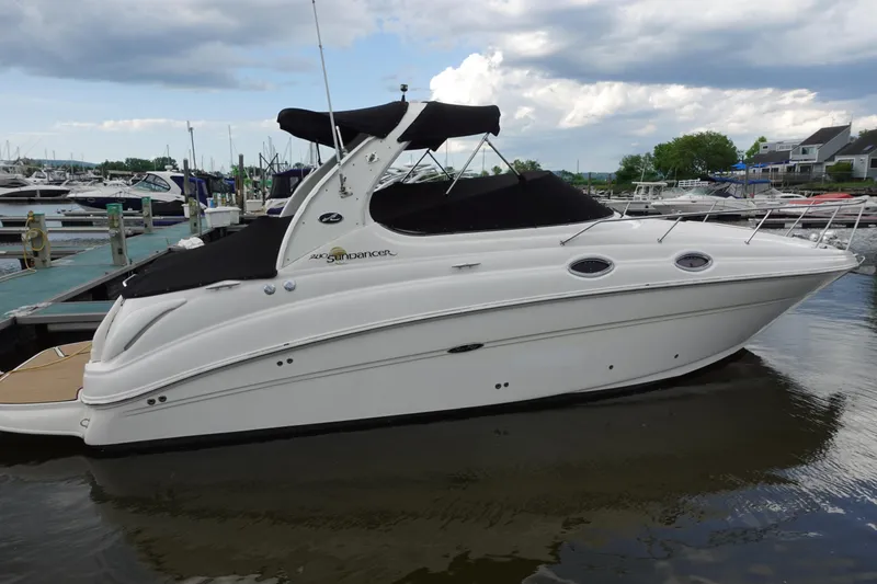The Image of 2007 Sea Ray 280 Sundancer boat docked at marina under cloudy sky. - 0
