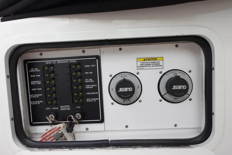 Slide: The Image of Main DC breaker panel on 2007 Sea Ray 280 Sundancer boat, featuring ignition switches and caution label. - 10