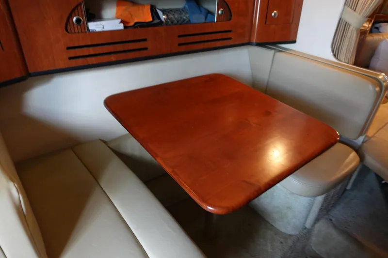 Slide: The Image of 2007 Sea Ray 280 Sundancer cabin with wooden table and beige seating. - 12