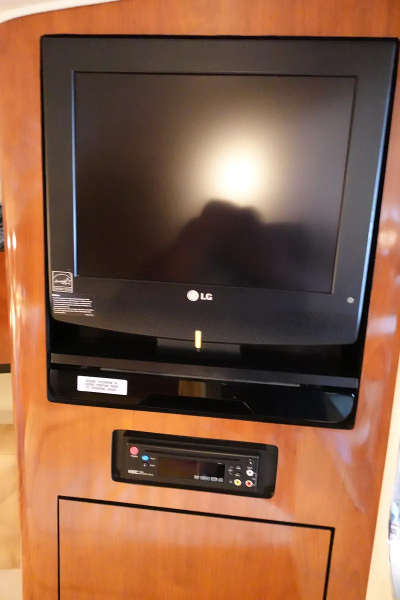 Slide: The Image of LG TV and control panel on 2007 Sea Ray 280 Sundancer yacht interior. - 13