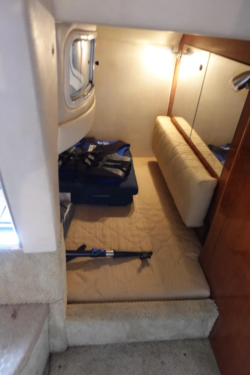 Slide: The Image of 2007 Sea Ray 280 Sundancer cabin interior with cozy sleeping area and soft lighting. - 15