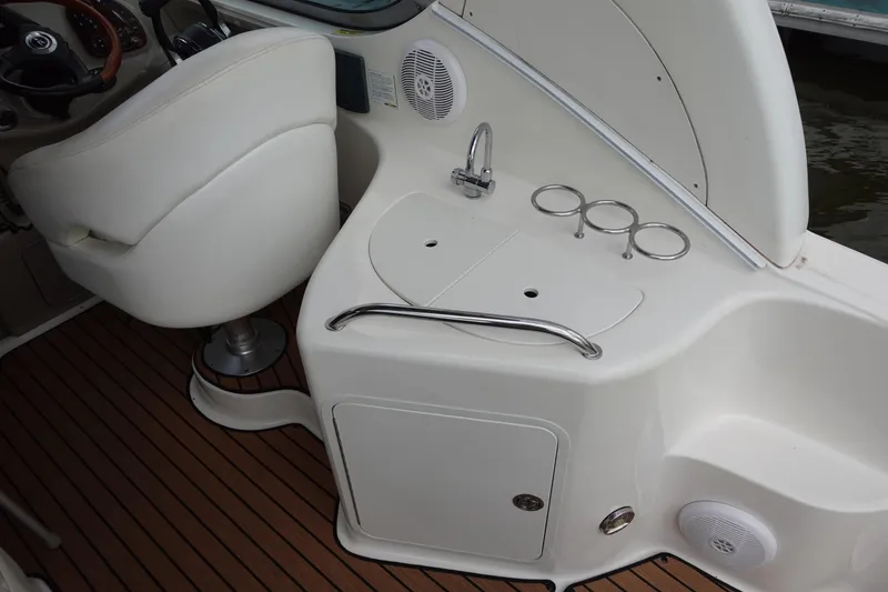 Slide: The Image of 2007 Sea Ray 280 Sundancer cockpit with helm seat, sink, and cup holders. - 6