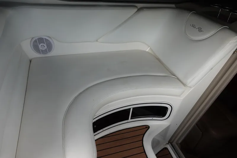 Slide: The Image of Interior seating of 2007 Sea Ray 280 Sundancer with white upholstery and wood flooring. - 7
