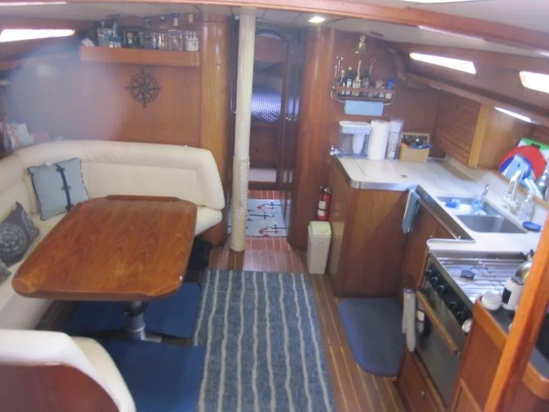 Slide: The Image of Interior of 1990 Jeanneau Sun Magic 44 yacht with kitchen and dining area. - 14