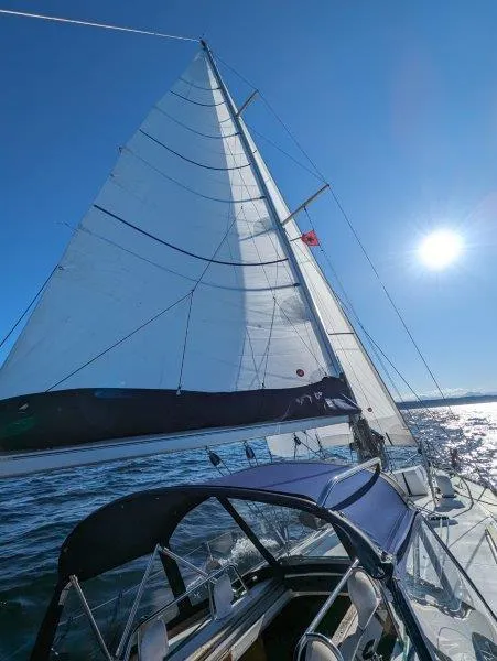 Slide: The Image of Sailing Jeanneau Sun Magic 44, 1990 model, under clear blue sky and bright sun. - 18