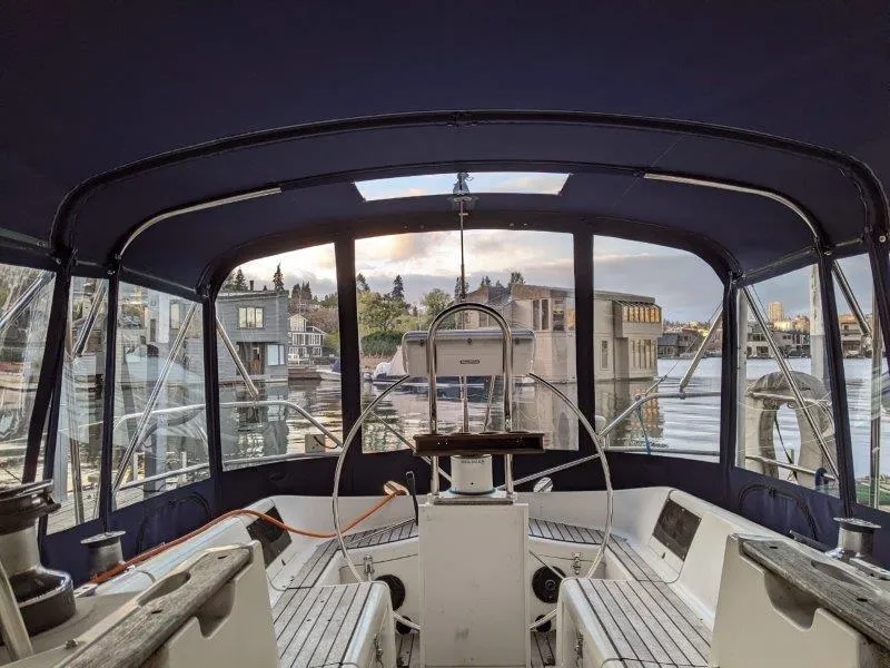 Slide: The Image of Cockpit view of 1990 Jeanneau Sun Magic 44 sailboat with marina backdrop. - 23