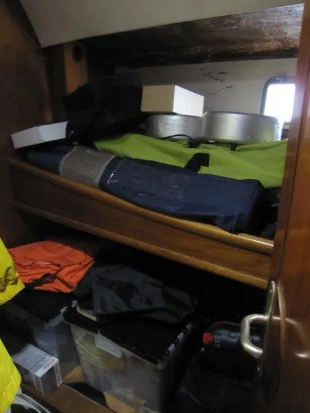 Slide: The Image of Storage compartment on a 1990 Jeanneau Sun Magic 44 yacht, filled with various items. - 4
