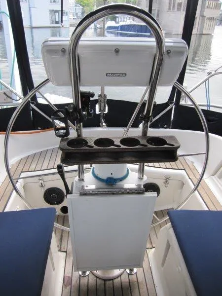 Slide: The Image of Cockpit of 1990 Jeanneau Sun Magic 44 sailboat with steering wheel and navigation equipment. - 44