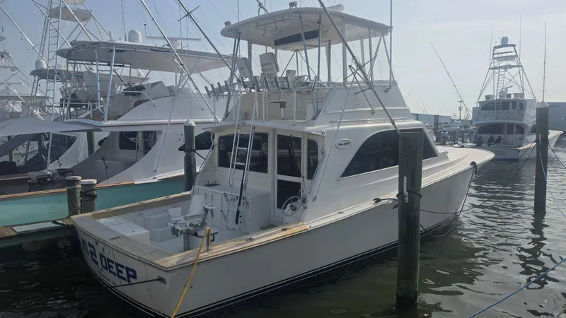 Slide: The Image of 1984 Ocean Yachts 46 Super Sport docked, showcasing its flybridge and sleek design. - 12