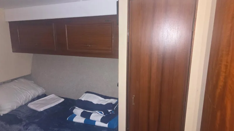 Slide: The Image of 1984 Ocean Yachts 46 Super Sport docked at marina under clear blue sky. - 16