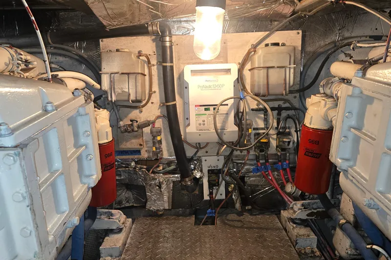 Slide: The Image of Engine room of 1984 Ocean Yachts 46 Super Sport with mechanical components and wiring. - 36