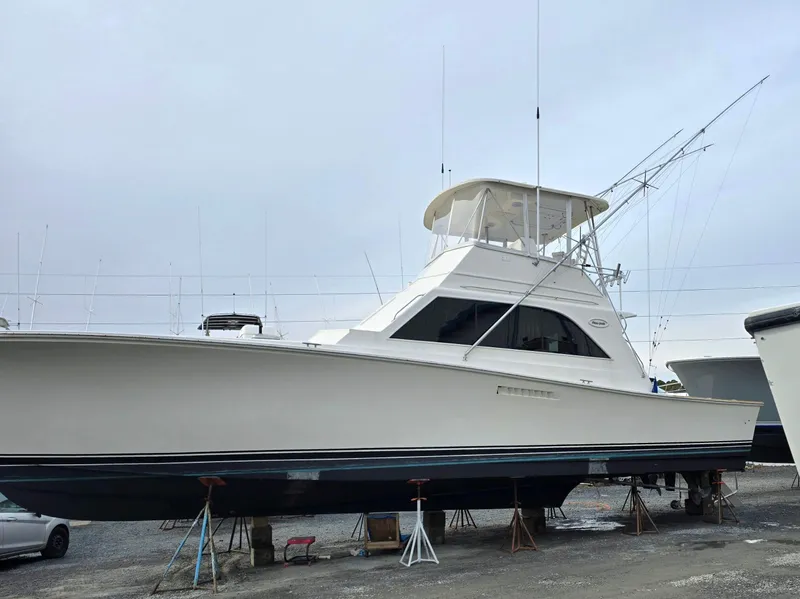 Slide: The Image of 1984 Ocean Yachts 46 Super Sport boat docked in a marina, side view. - 2