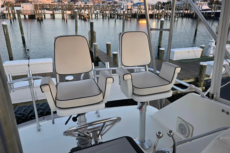 Slide: The Image of Two captain chairs on 1984 Ocean Yachts 46 Super Sport, overlooking marina. - 35