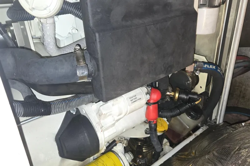 Slide: The Image of Engine compartment of a 1984 Ocean Yachts 46 Super Sport, showcasing hoses and connections. - 37