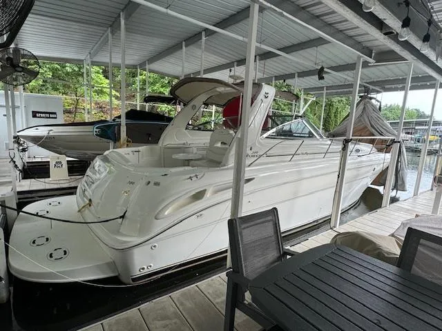 The Image of 1999 Sea Ray 38' Sundancer docked in a covered marina. - 0